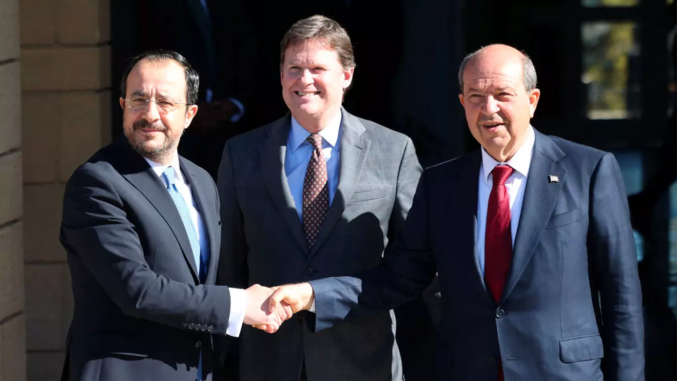President Nikos Christodoulides, who leads Cyprus's Greek Cypriot community, and Turkish Cypriot leader Ersin Tatar shake hands after a meeting in the presence of UN Cyprus representative Colin Stewart in the UN buffer zone in the capital Nicosia, Cyprus January 20, 2025. Reuters/Yiannis Kourtoglou