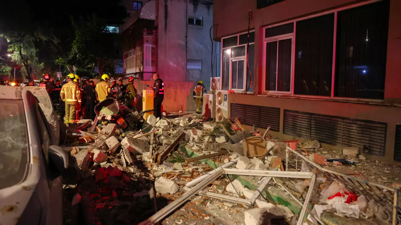 Emergency personnel inspect damage in a building following an Iranian projectile strike, amid the U.S.-Israeli conflict with Iran, in central Israel, March 18, 2026. Reuters/Nir Elias