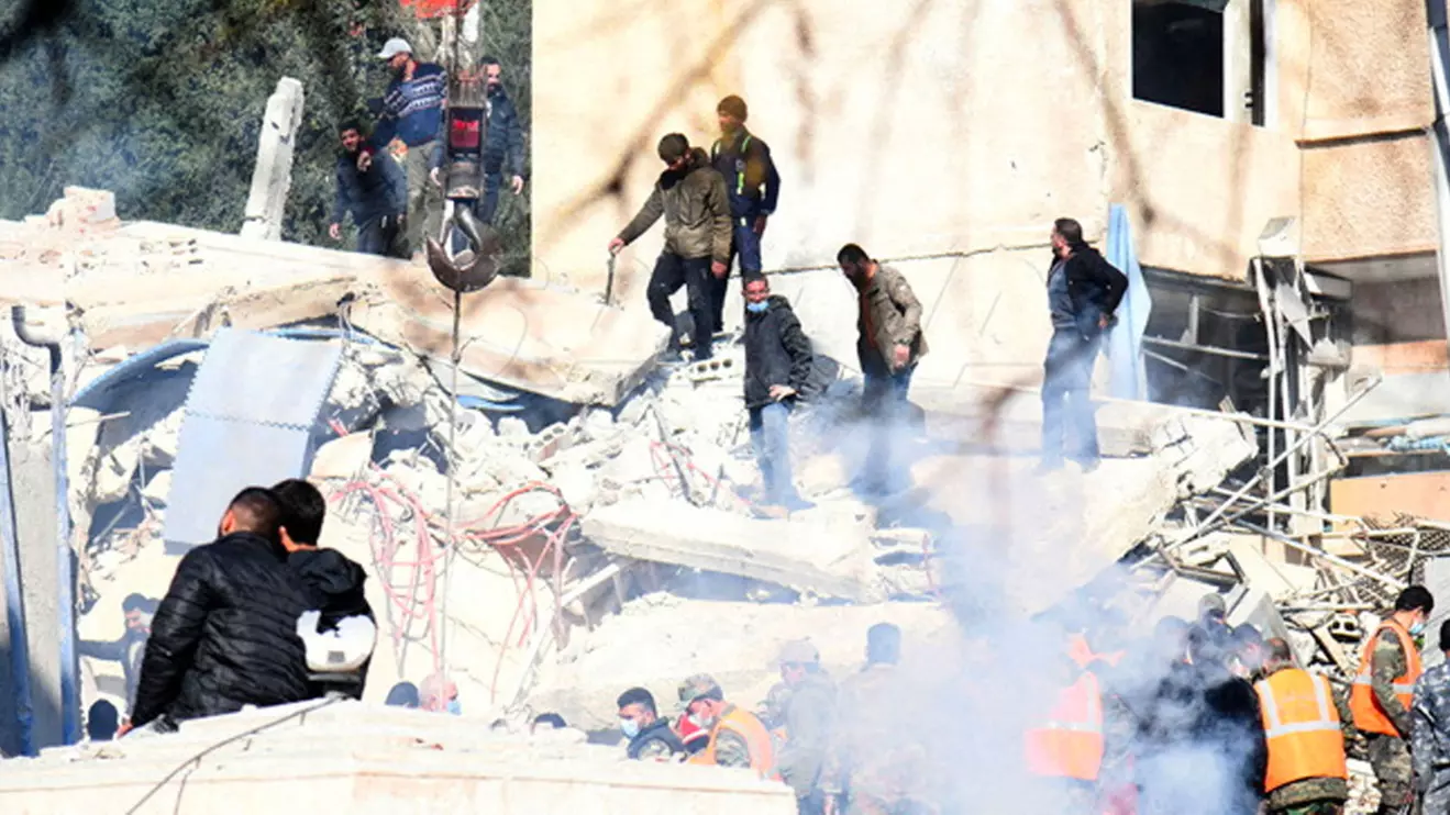 People inspect the damage at the site of an Israeli strike, according to sources, in the Mazzeh neighborhood of Damascus, SANA/Handout via Reuters