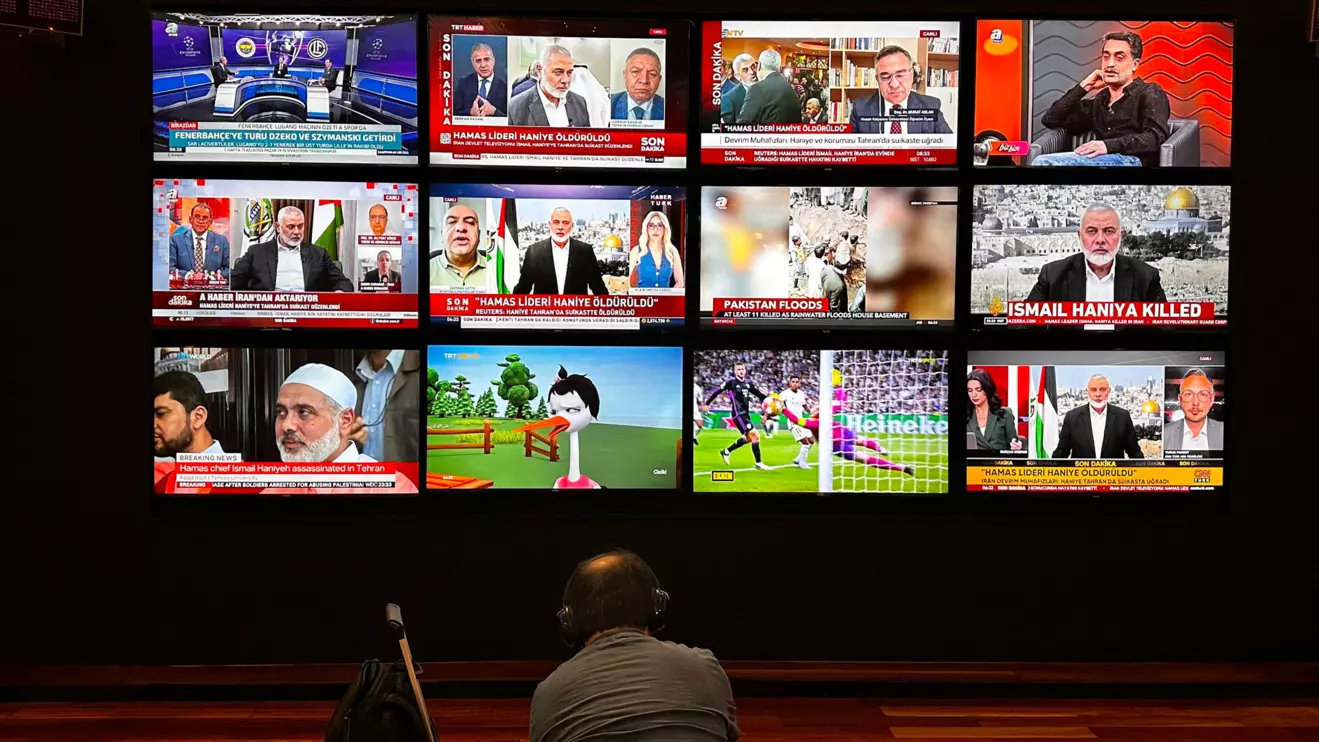 A person watches the news on multiple TV screens, most of them announcing the killing of senior Hamas leader Ismail Haniyeh, in Istanbul, Turkey, July 31, 2024. Reuters/Alkis Konstantinidis