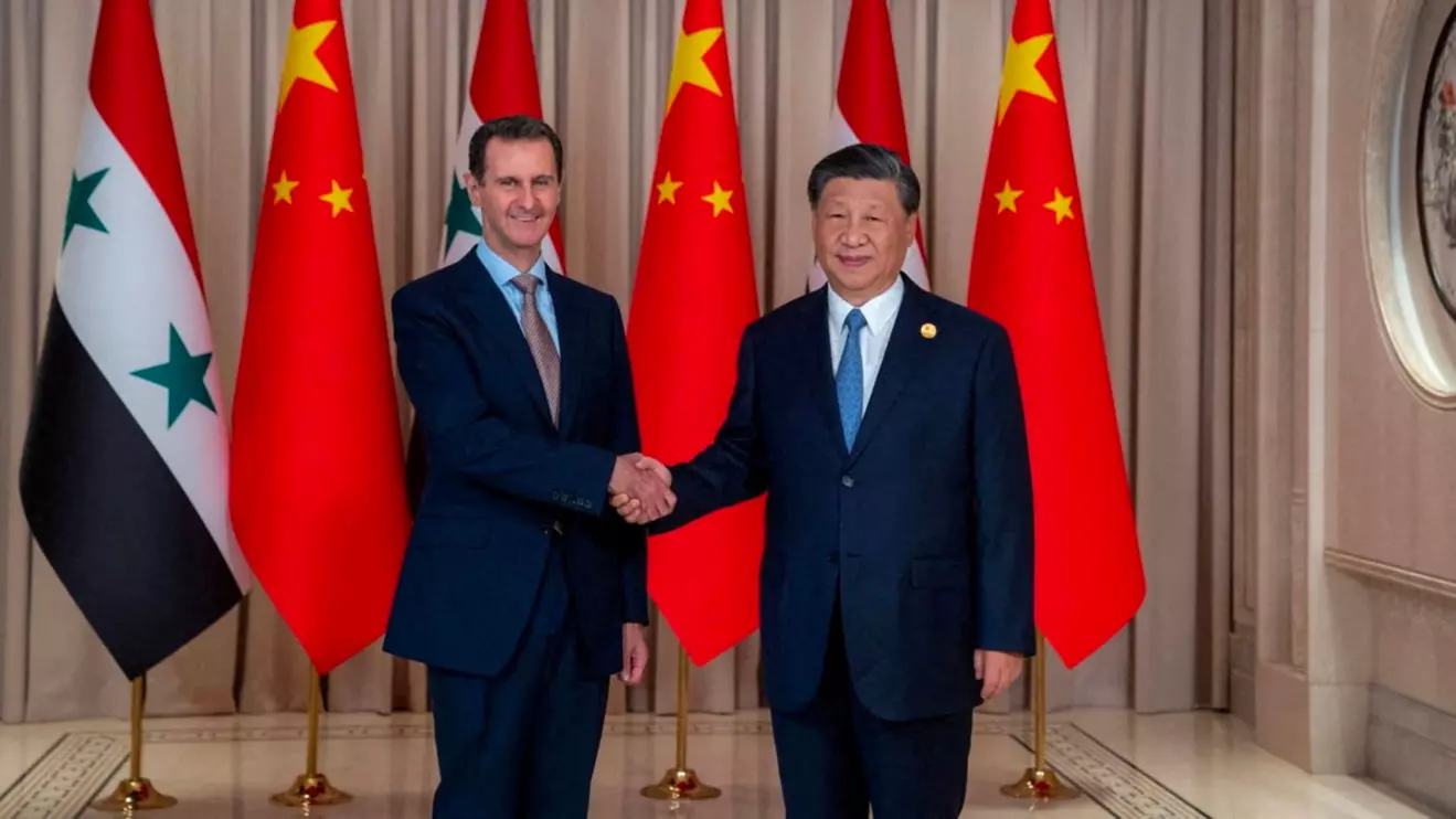 Chinese President Xi Jinping shakes hands with Syria's President Bashar al-Assad in eastern Hangzhou city, in this handout picture released by Sana on September 22, 2023, SANA/Handout via Reuters