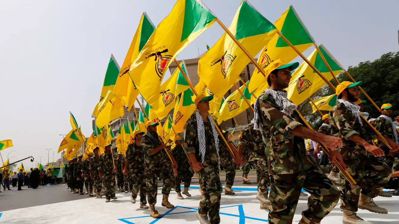 Iraqi Shi'ite Muslim men from the Iranian-backed group Kataib Hezbollah, Reuters/Thaier al-Sudani