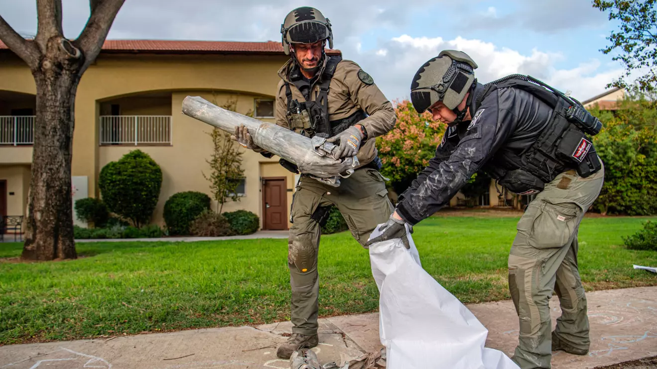 Israeli explosive experts policemen put in a sack a part of a projectile, after projectiles crossed over to Israel from Lebanon, amid ongoing hostilities between Hezbollah and Israel, in a Kibbutz in northern Israel, November 24, 2024. Reuters/Gil Eliyahu