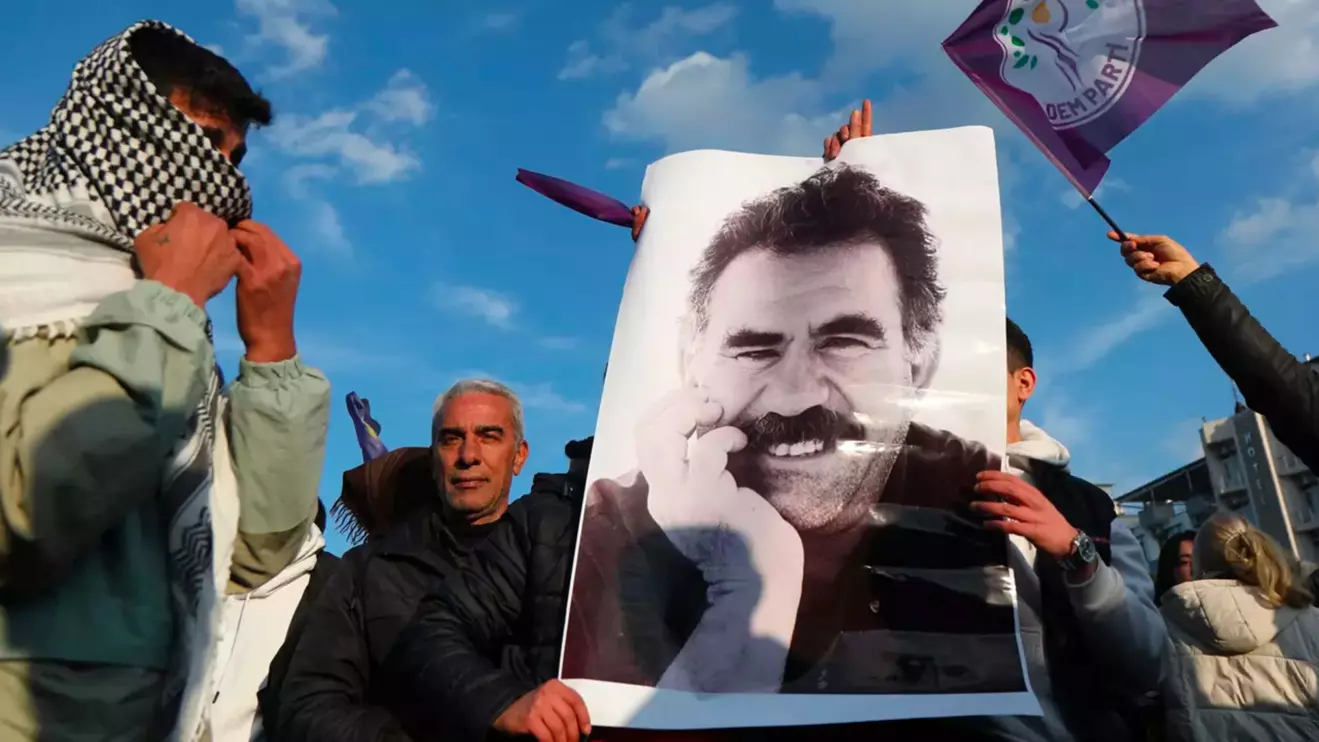 A demonstrator holds a picture of jailed Kurdish militant leader Abdullah Ocalan during a rally in Diyarbakir, Turkey, February 27, 2025. Reuters/Sertac Kayar