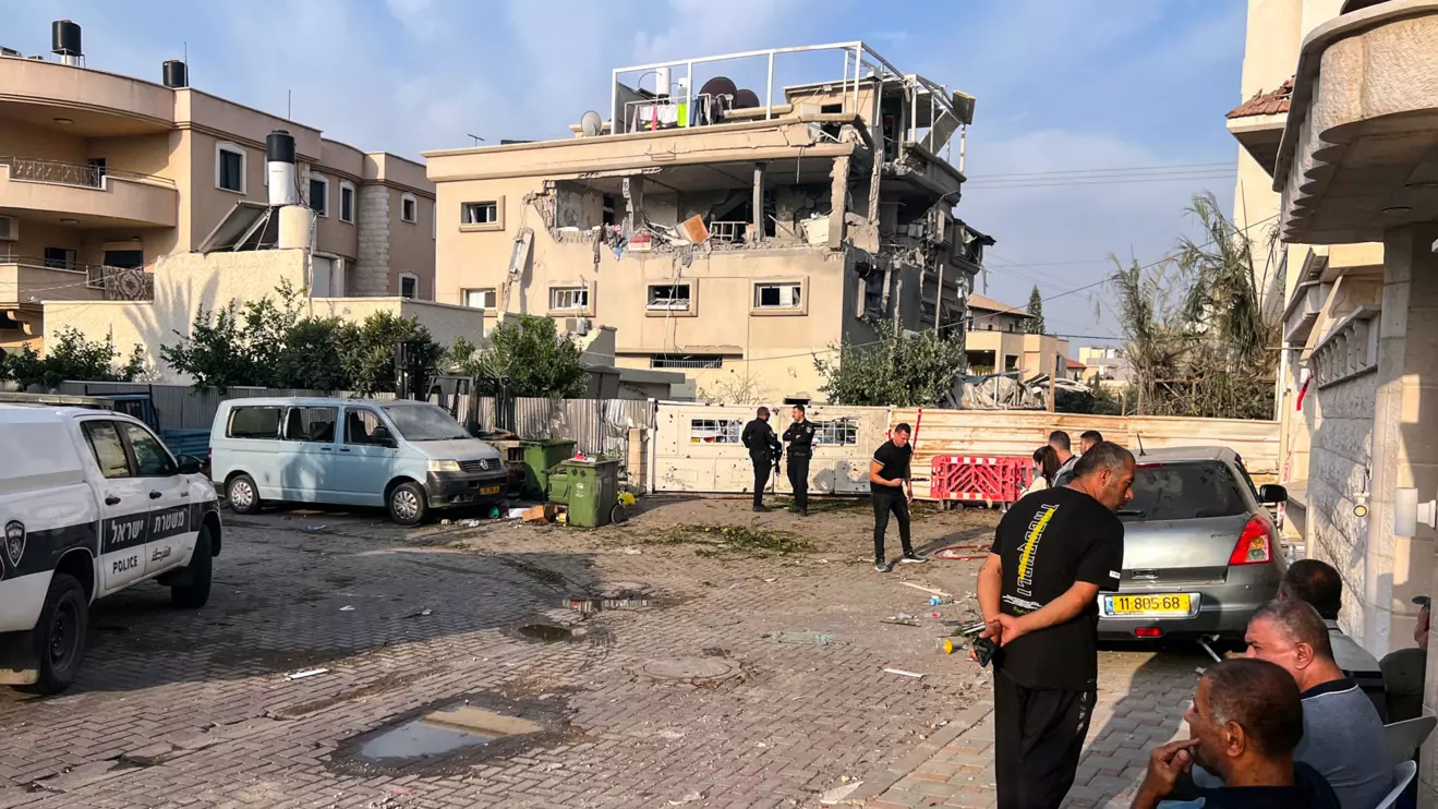 Residents and police officials gather near a house that was hit, following a projectiles attack from Lebanon towards Israel, amid cross-border hostilities between Hezbollah and Israel, in the central Israeli town of Tira, November 2, 2024. Reuters/Rami Amichay