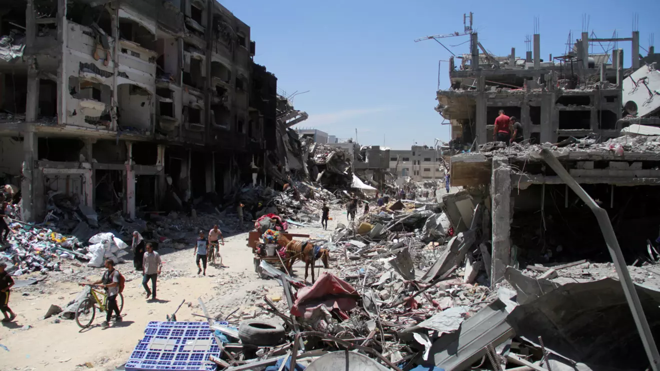 Palestinians walk, as they inspect the damage after Israeli forces withdrew from Jabalia refugee camp, following a raid, in the northern Gaza Strip, May 31, 2024. Reuters/Mahmoud Issa