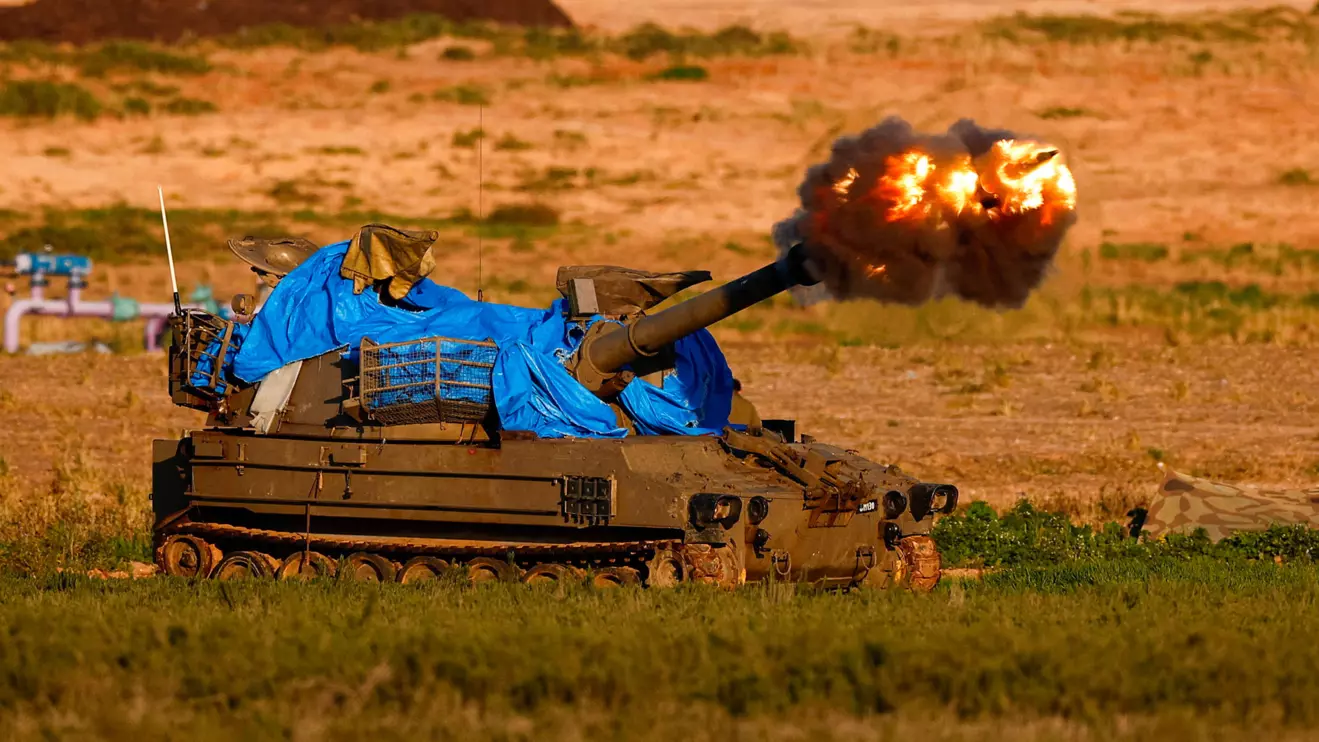 An Israeli mobile artillery unit fires towards Gaza, Reuters/Amir Cohen