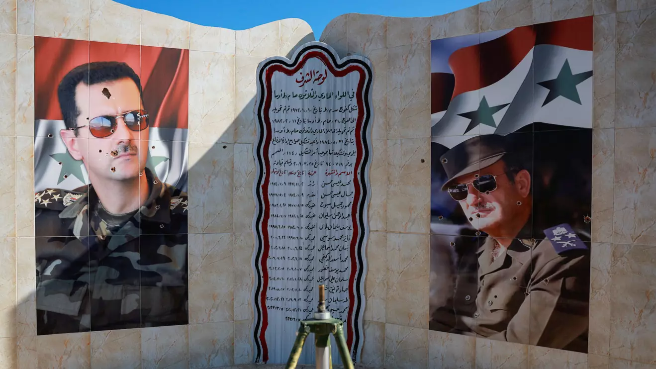 Images of Syria's Bashar al-Assad and former Syrian President Hafez al-Assad are damaged by bullet holes, as fighters of the ruling Syrian body inspect the damage at a military site, in the aftermath of an Israeli strike, December 14, 2024. Reuters/Ammar Awad