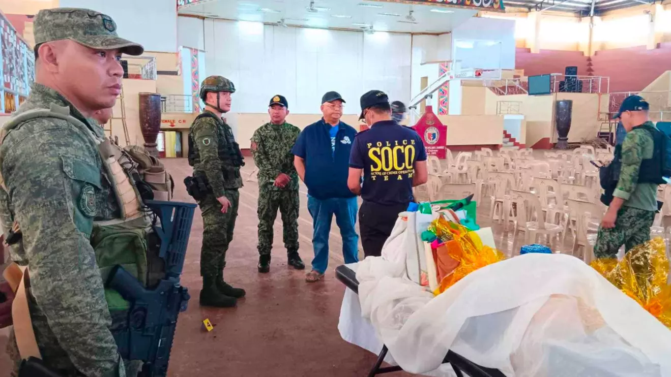 Lanao Del Sur Governor Mamintal Adiong Jr. stands among law enforcement officers as they investigate the scene of an explosion that occurred during a Catholic Mass in a gymnasium at Mindanao State University in Marawi, Philippines, December 3, 2023. Lanao Del Sur Provincial Government/Handout via Reuters