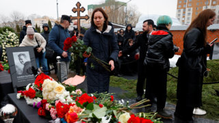 Navalny's parents bury their son as thousands chant his name