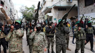 Battling to survive, Hamas faces defiant clans and doubts over Iran