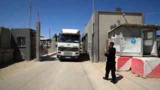 Under Hamas threats, US-backed Gaza group halts aid operations for a day