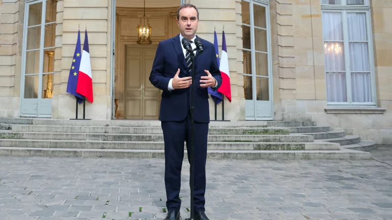 France's Macron tasks his outgoing PM with holding last-ditch talks to end crisis