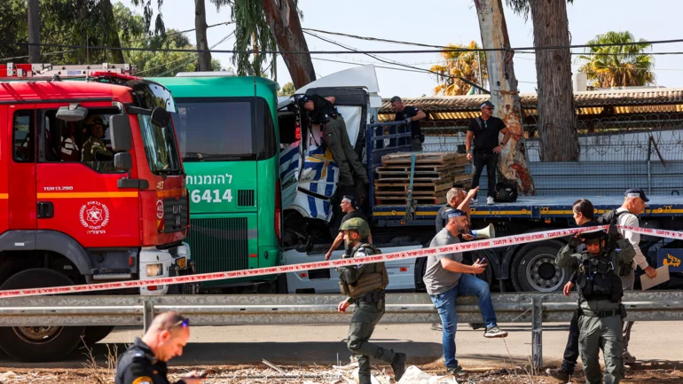 One killed, dozens injured in truck ramming at Israeli bus stop