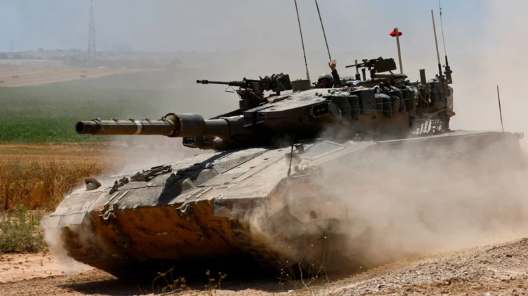 Battles rage across Gaza, Israel releases images of armed men at UN site